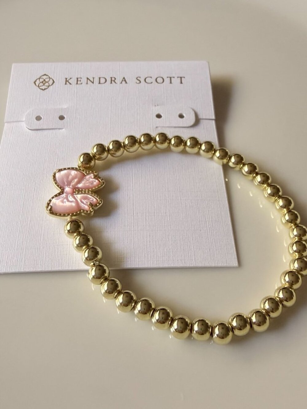 Kendra Scott Gold Beaded Stretch Bracelet with Pink Butterfly Charm